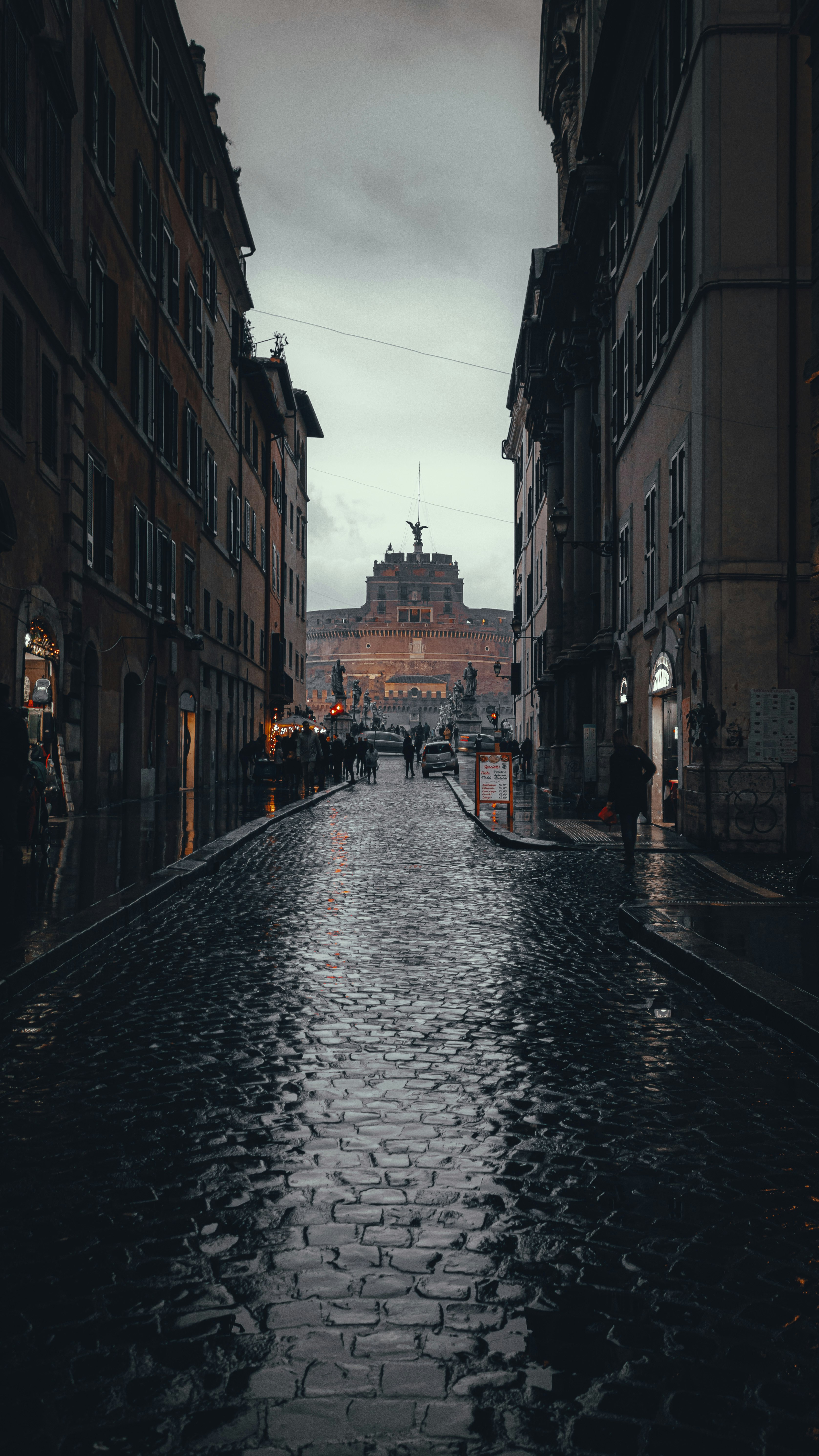 people walking on street between buildings during daytime